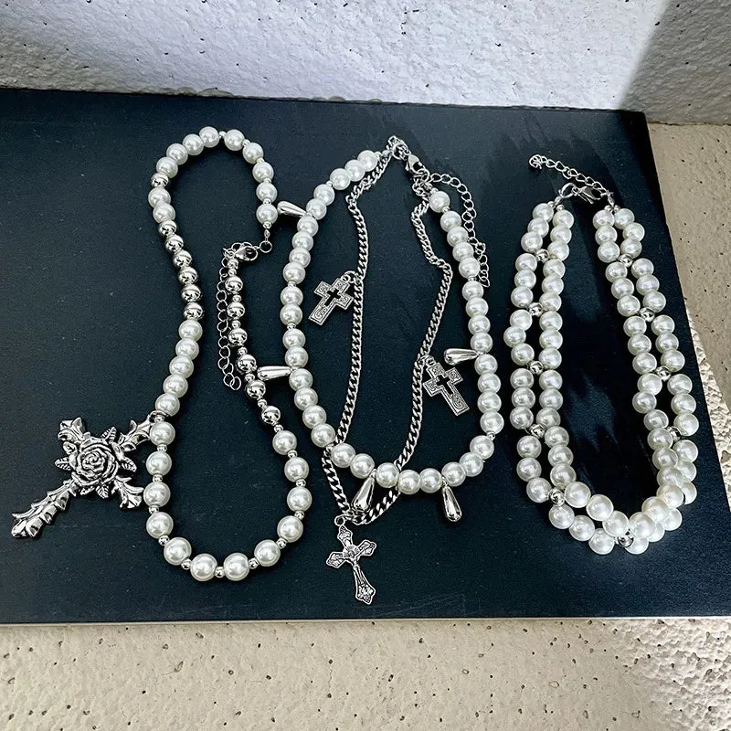 Pearl beaded necklaces are layered with men's and women's sweaters