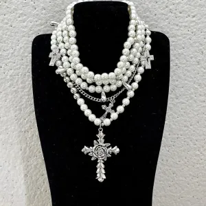 Pearl beaded necklaces are layered with men's and women's sweaters